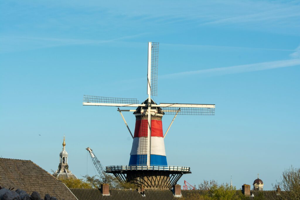 Explore the historic Molen de Valk windmill in vibrant Leiden, Netherlands on a clear, sunny day.